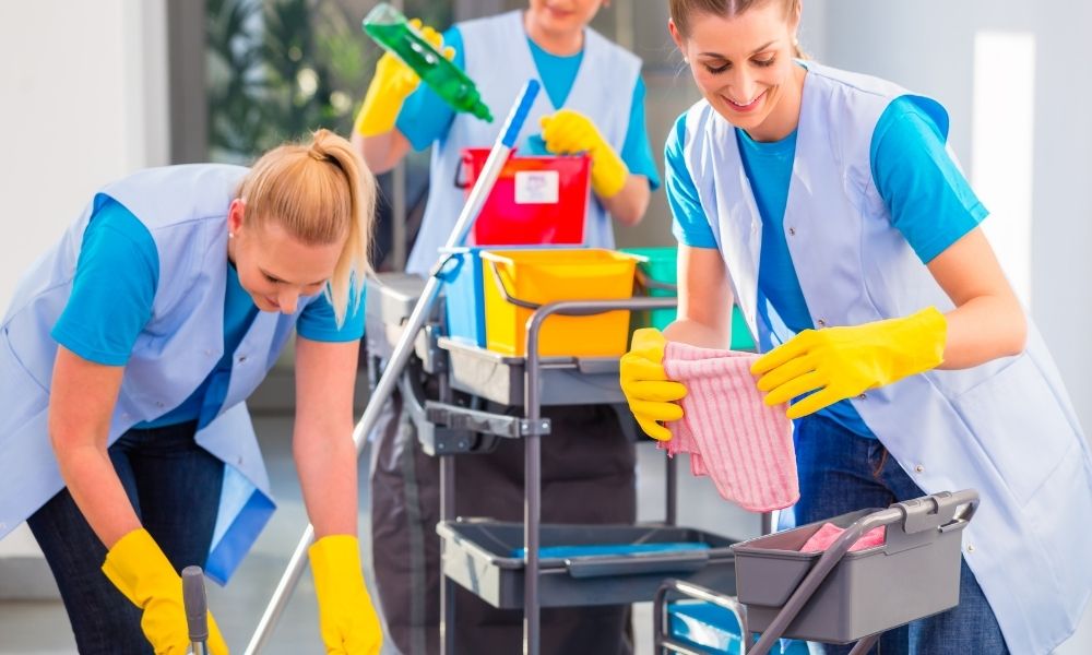 A photo of commercial cleaner specialist using professional equipment to clean office floors efficiently