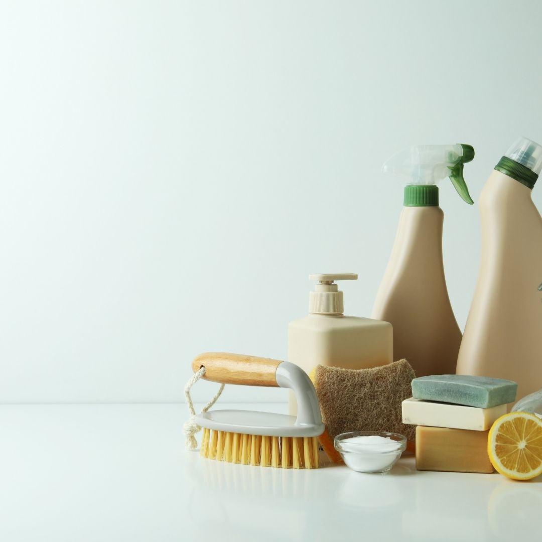 Green cleaning crew using plant-based products to sanitize an office space sustainably.